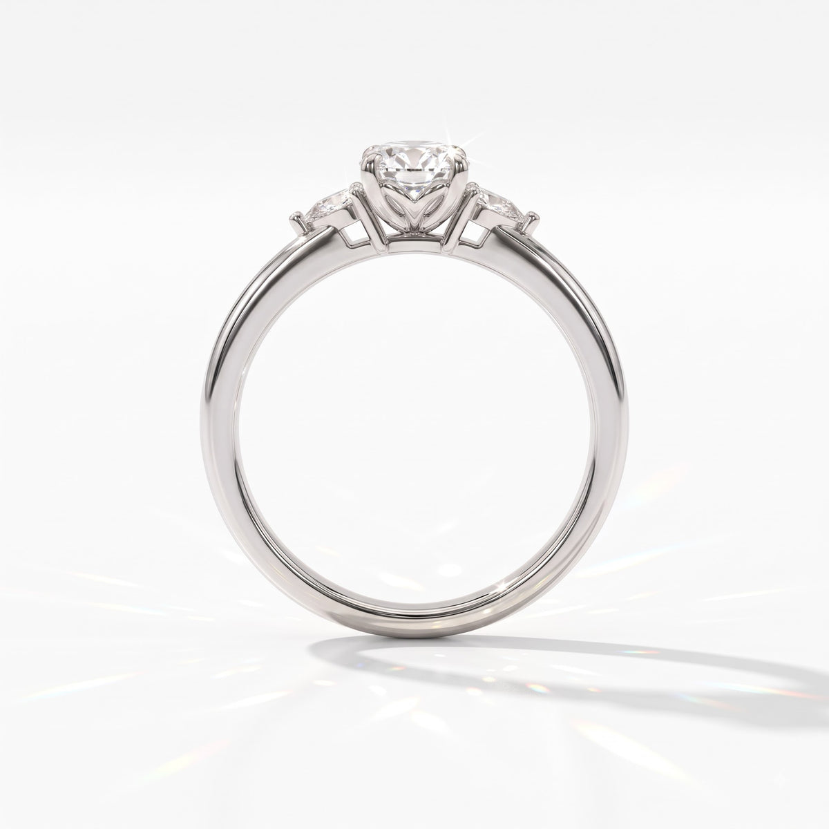 Oval cut lab-grown diamond three-stone engagement ring with pear side stones in 14K (585) white gold, upright profile view