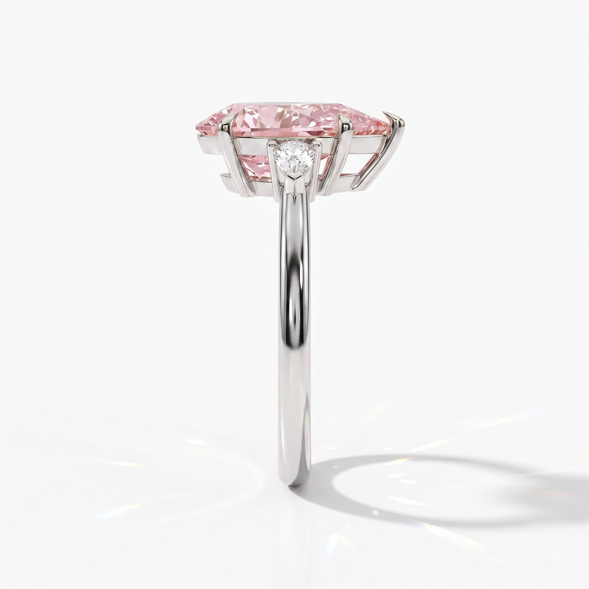 Fancy Vivid Pink pear cut lab-grown diamond three-stone ring with pear side diamonds in 14K (585) white gold, side view