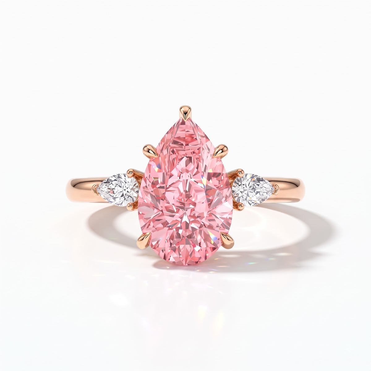 Fancy Vivid Pink pear cut lab-grown diamond three-stone ring with pear side diamonds in 14K (585) rose gold, front view