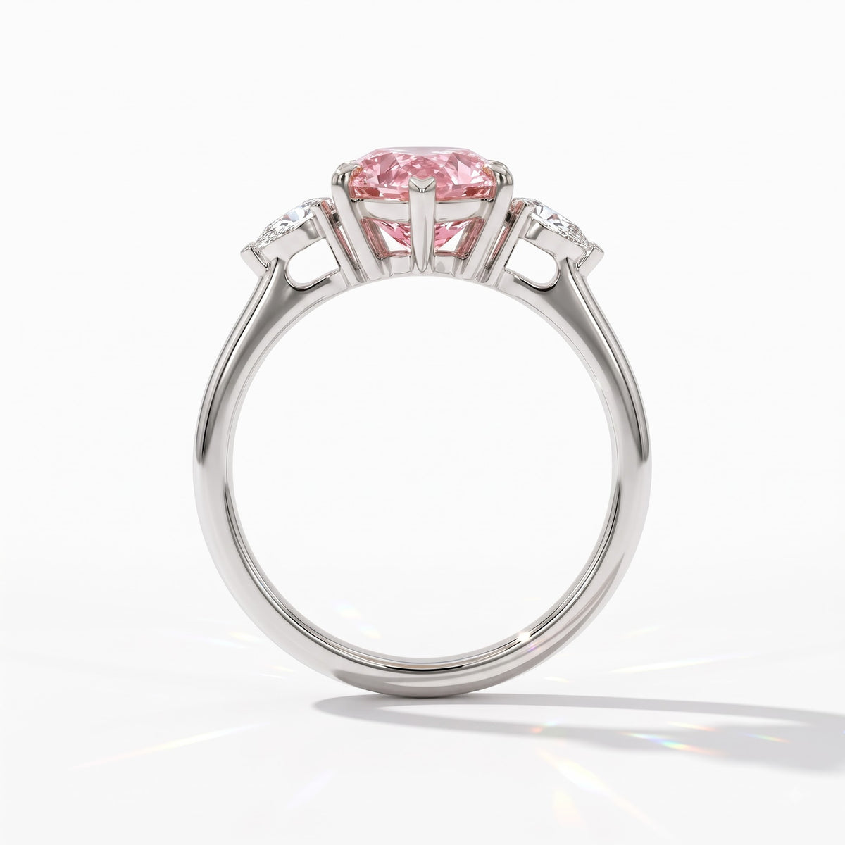 Fancy Vivid Pink pear cut lab-grown diamond three-stone ring with pear side diamonds in 14K (585) white gold, upright profile view