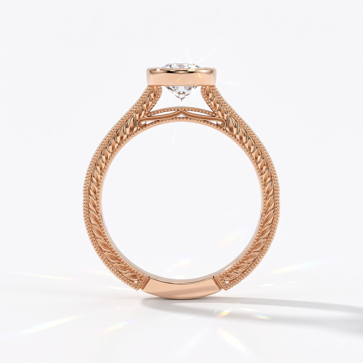 Pear cut lab-grown diamond vintage bezel engagement ring with hand-engraved milgrain band in 14K (585) rose gold, upright profile view