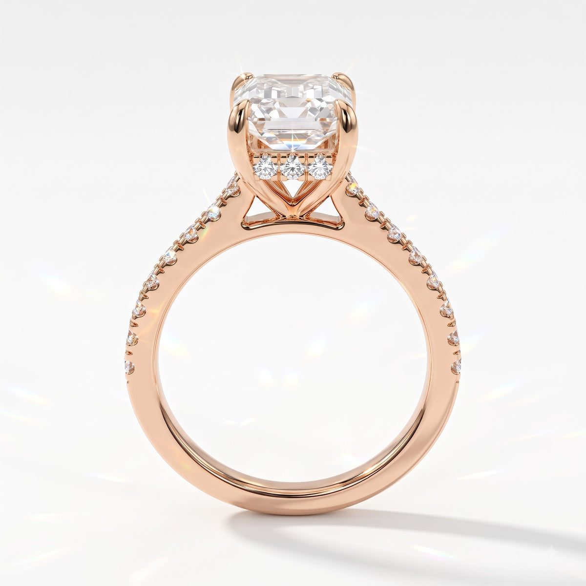 Emerald cut lab-grown diamond hidden halo engagement ring with pavé band in 18K (750) rose gold, upright profile view