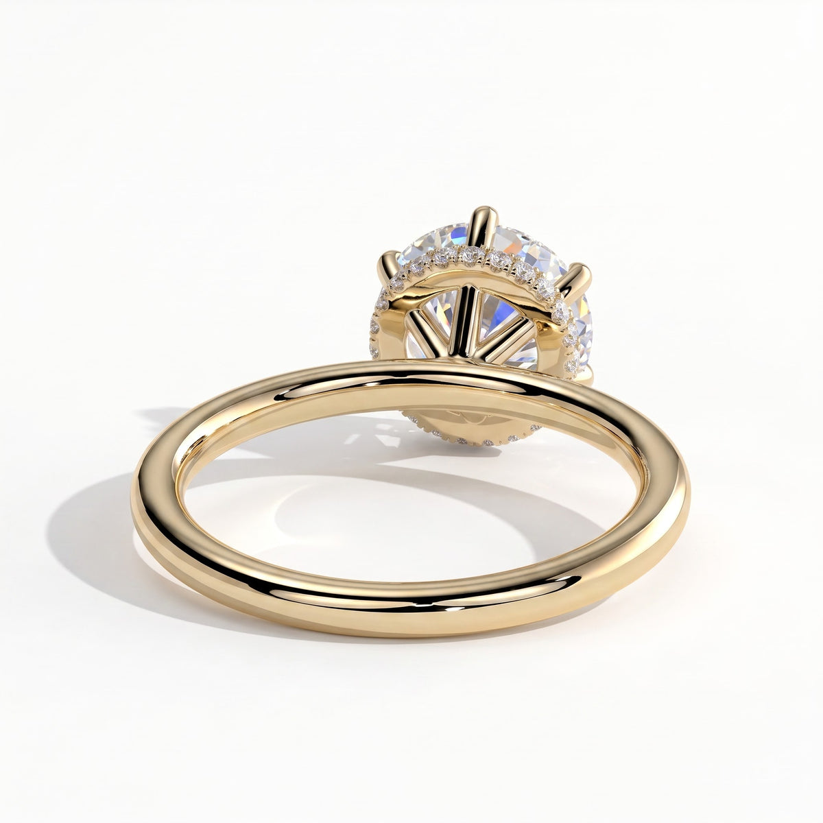 Round lab-grown diamond solitaire engagement ring in 18K (750) yellow gold, on white background