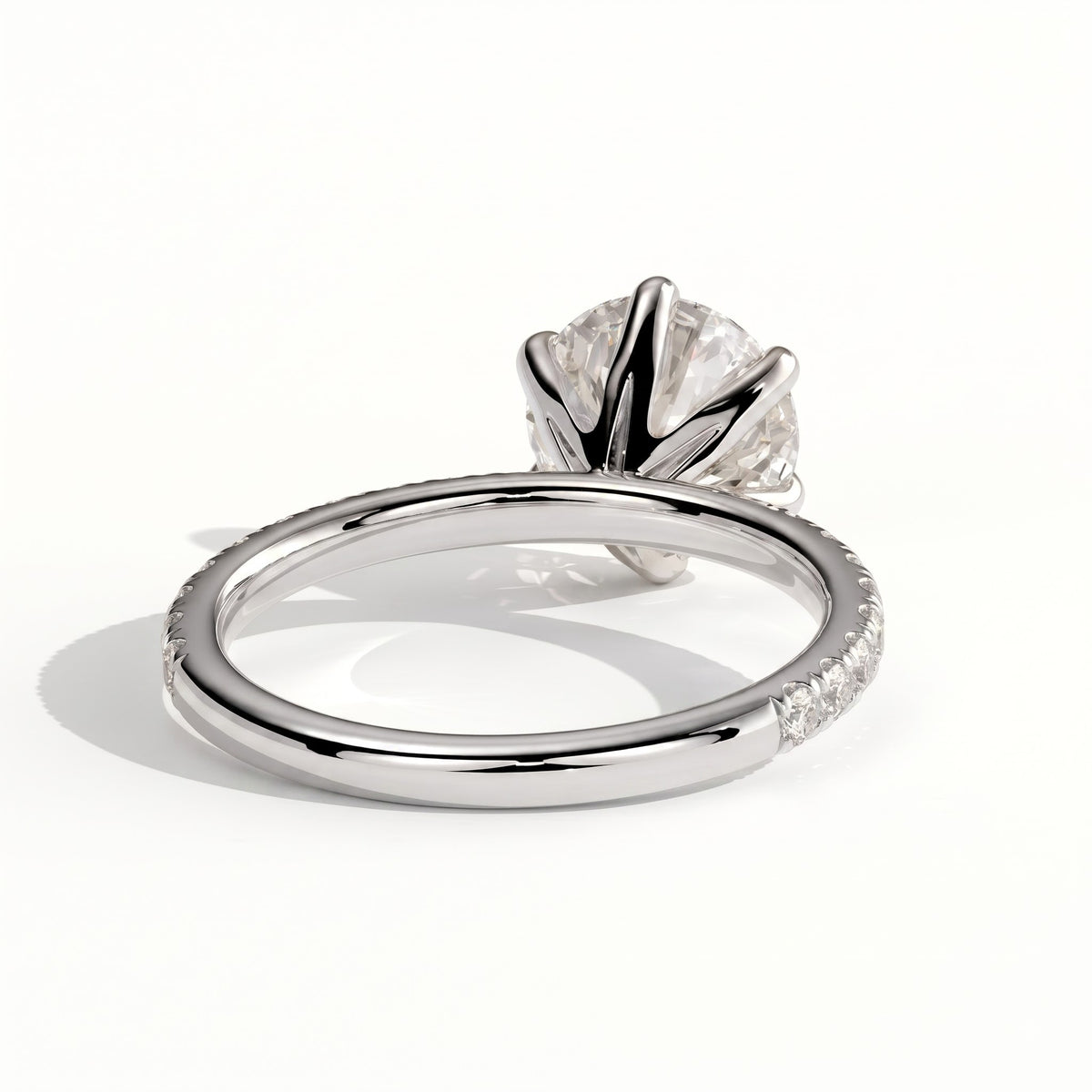 Round lab-grown diamond halo engagement ring in 950 platinum, on white background