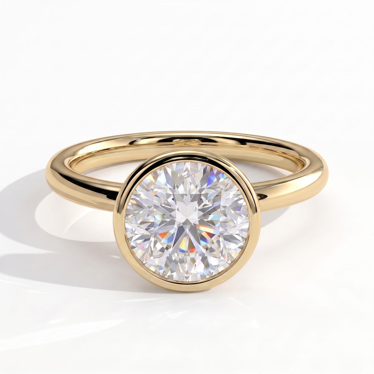 Round lab-grown diamond bezel-set solitaire engagement ring in 14K (585) yellow gold, front view