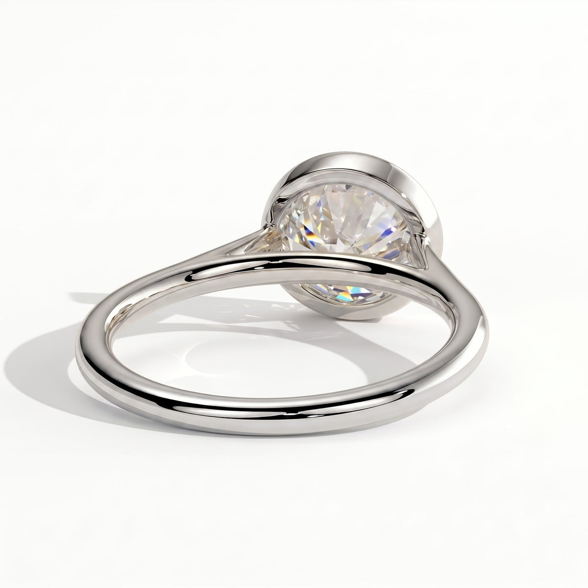 Round lab-grown diamond bezel-set solitaire engagement ring in 14K (585) white gold, on white background