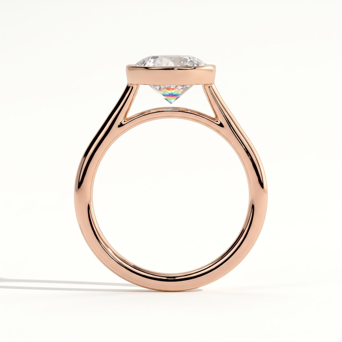 Round lab-grown diamond bezel-set solitaire engagement ring in 18K (750) rose gold, side profile