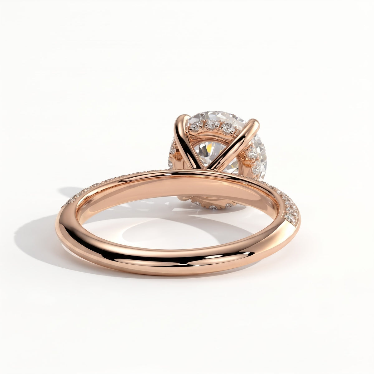 Round lab-grown diamond halo engagement ring in 14K (585) rose gold, on white background