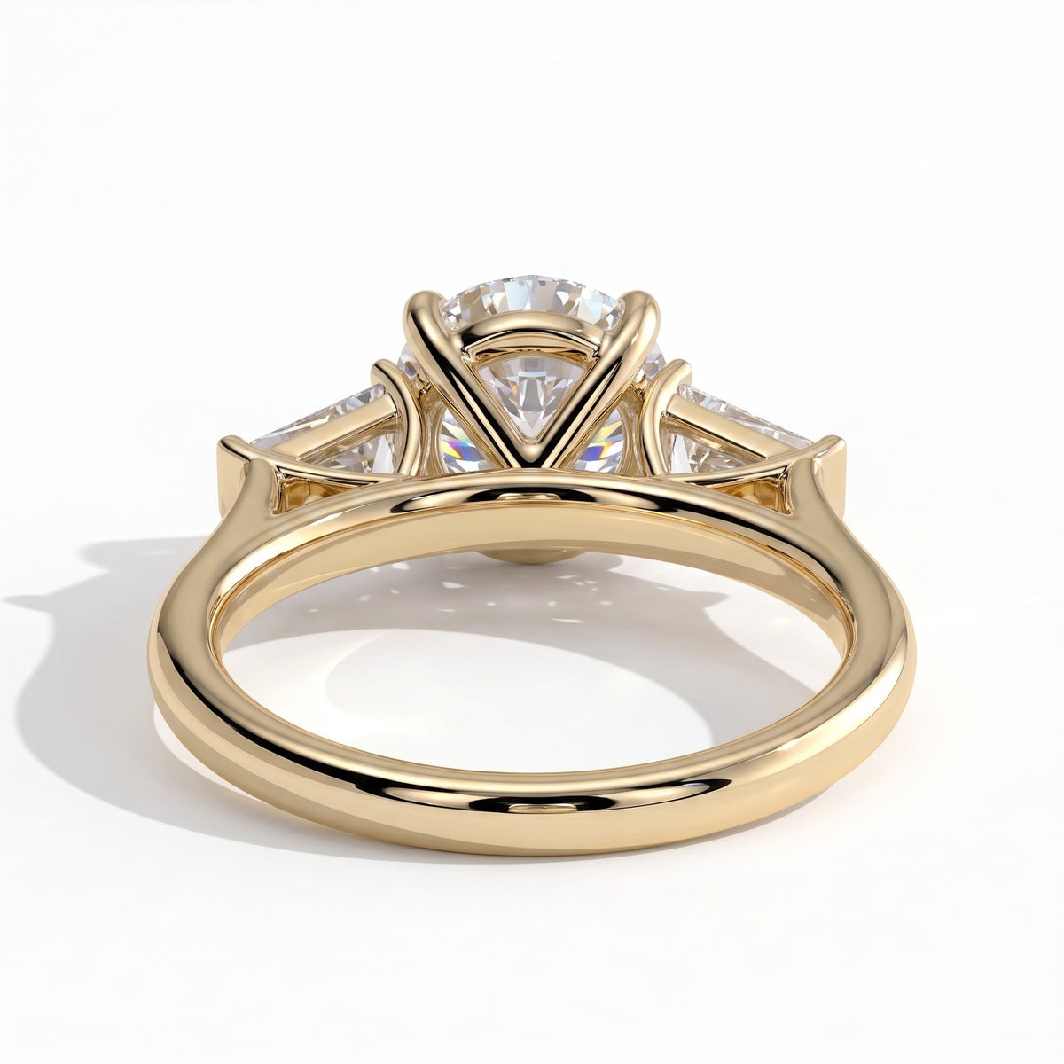Round lab-grown diamond three-stone engagement ring in 14K (585) yellow gold, on white background