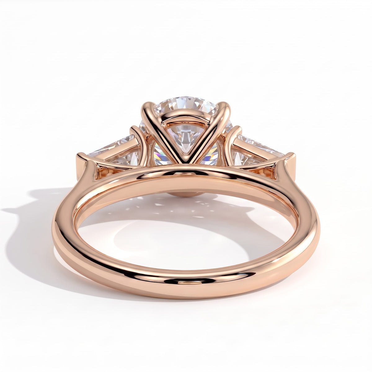 Round lab-grown diamond three-stone engagement ring in 14K (585) rose gold, on white background
