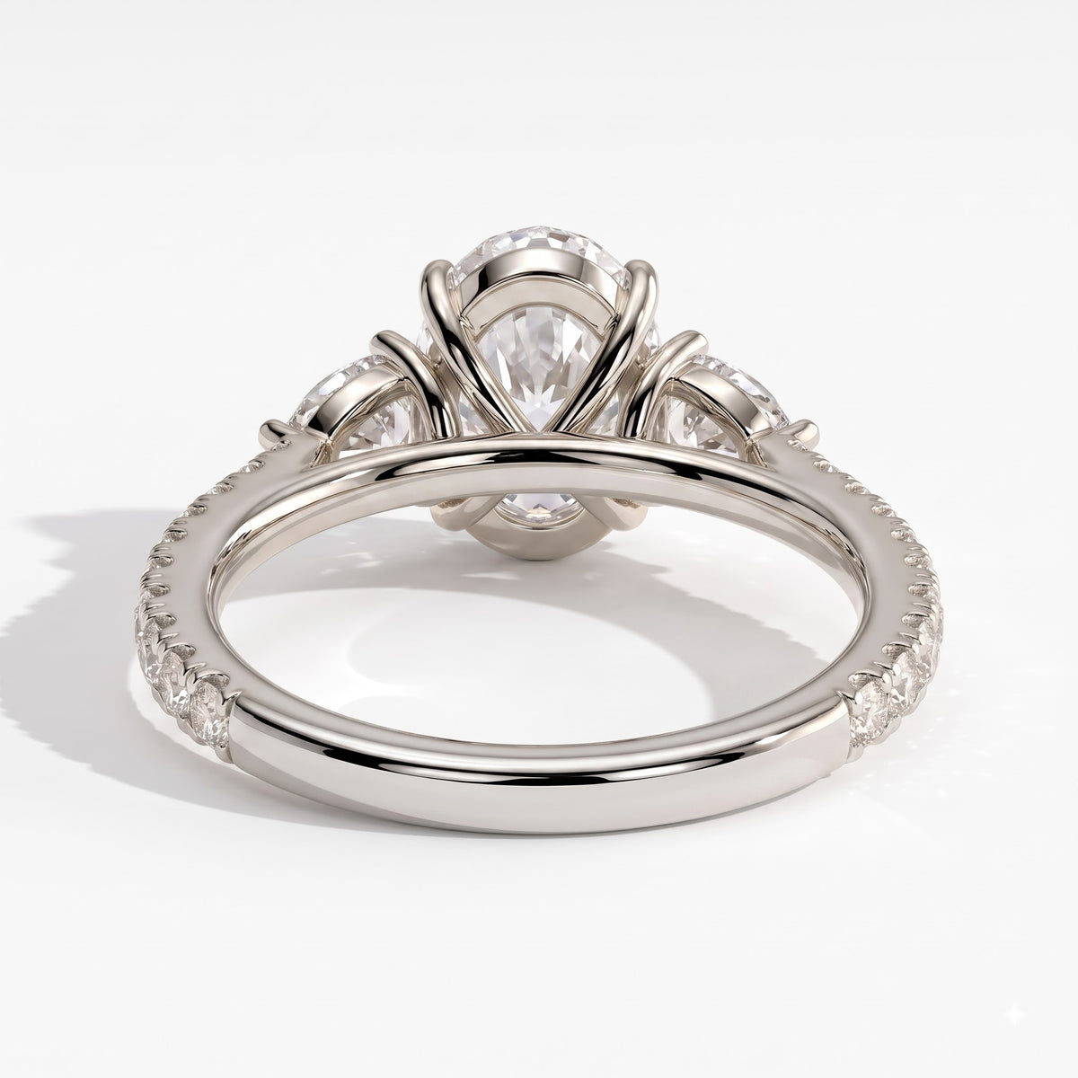 Oval lab-grown diamond three-stone engagement ring in 18K (750) white gold, on white background