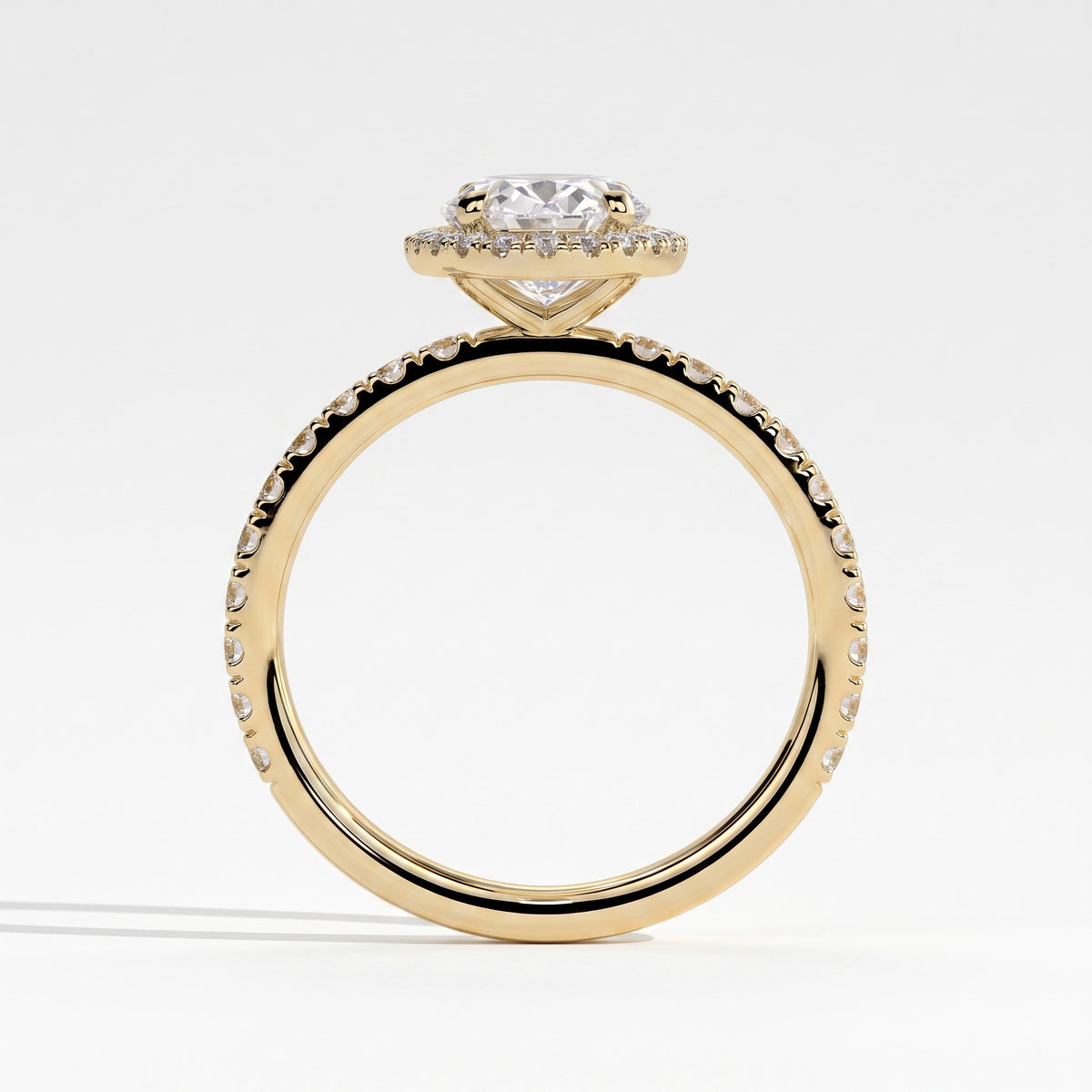 Oval lab-grown diamond halo engagement ring in 18K (750) yellow gold, side profile