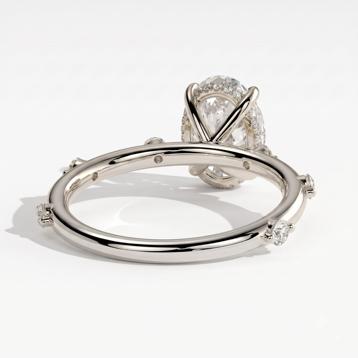Oval lab-grown diamond halo engagement ring in 950 platinum, on white background
