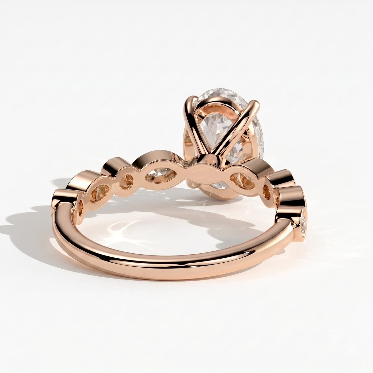 Oval lab-grown diamond bezel-set halo engagement ring in 14K (585) rose gold, on white background