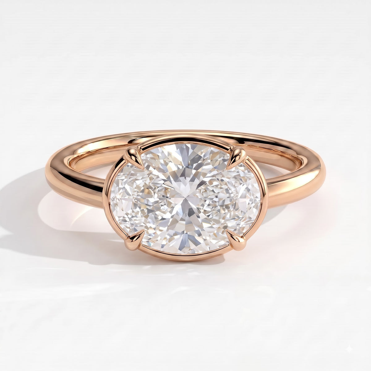 Oval lab-grown diamond bezel-set east-west solitaire engagement ring in 18K (750) rose gold, front view