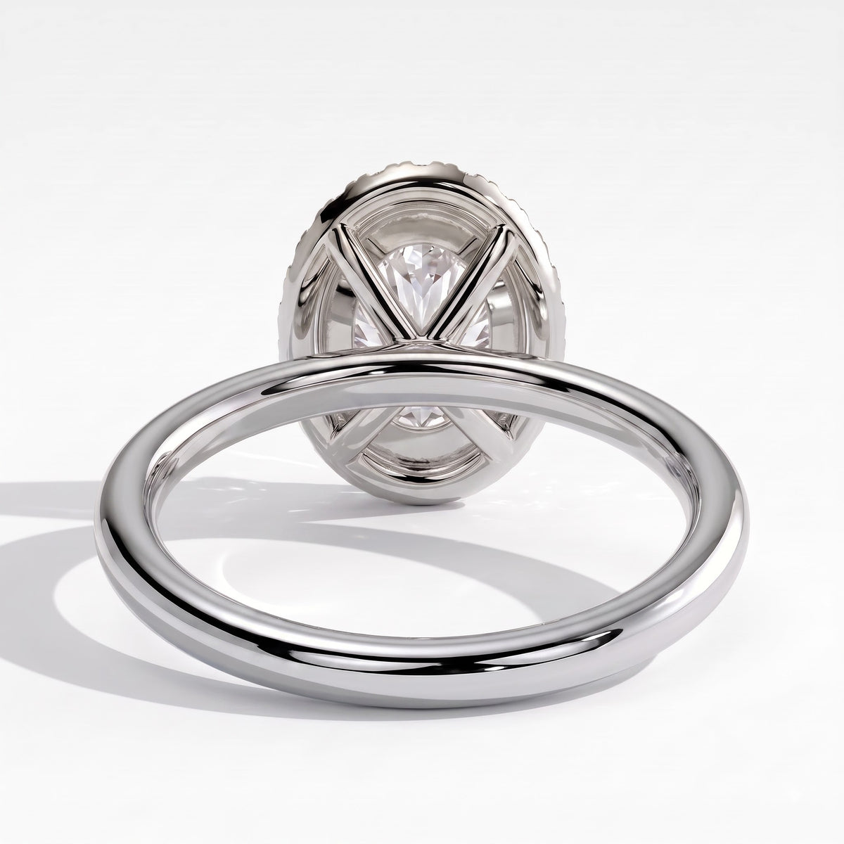 Oval lab-grown diamond halo engagement ring in 950 platinum, on white background