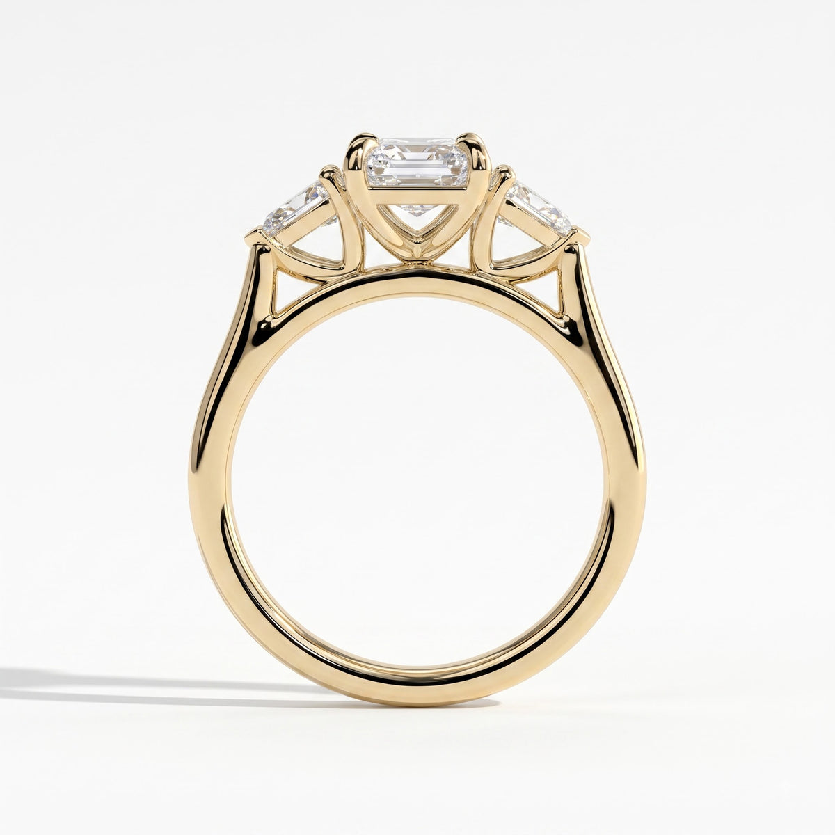Emerald lab-grown diamond three-stone engagement ring in 14K (585) yellow gold, side profile
