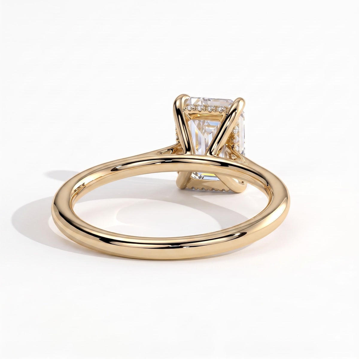 Radiant lab-grown diamond halo engagement ring in 18K (750) yellow gold, on white background