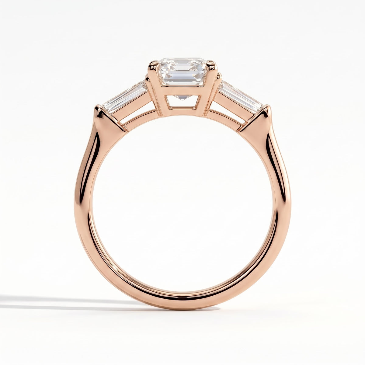 Emerald lab-grown diamond three-stone engagement ring in 14K (585) rose gold, side profile