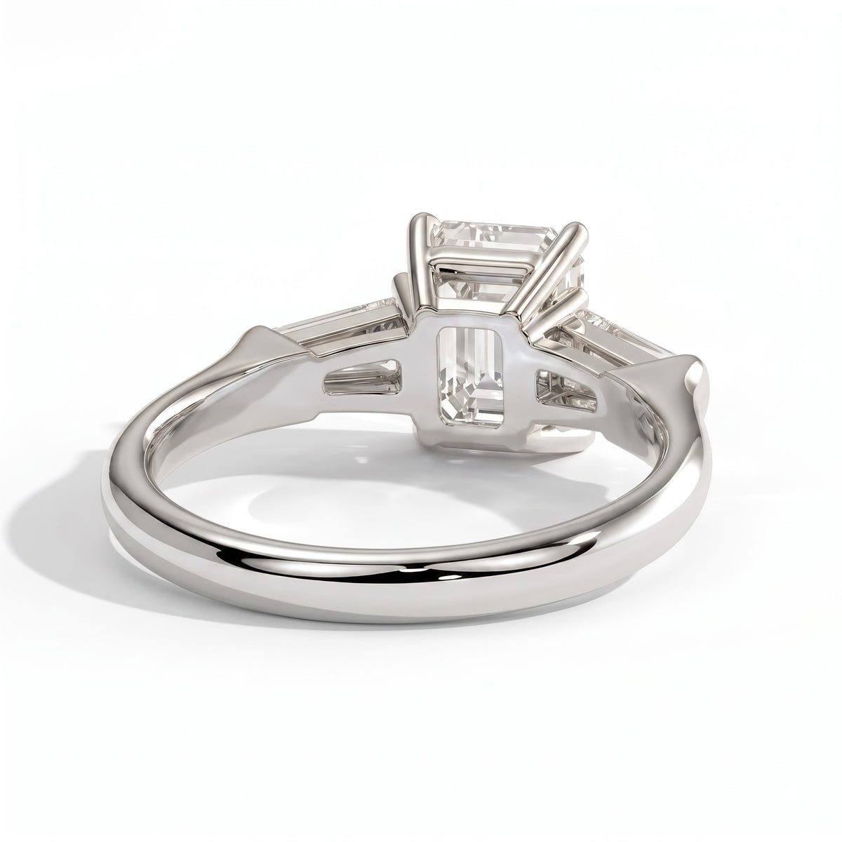 Emerald lab-grown diamond three-stone engagement ring in 18K (750) white gold, on white background