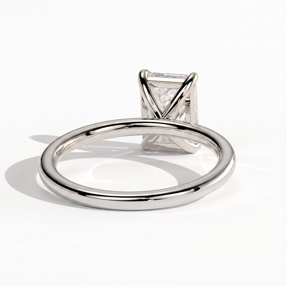 Emerald lab-grown diamond solitaire engagement ring in 950 platinum, on white background