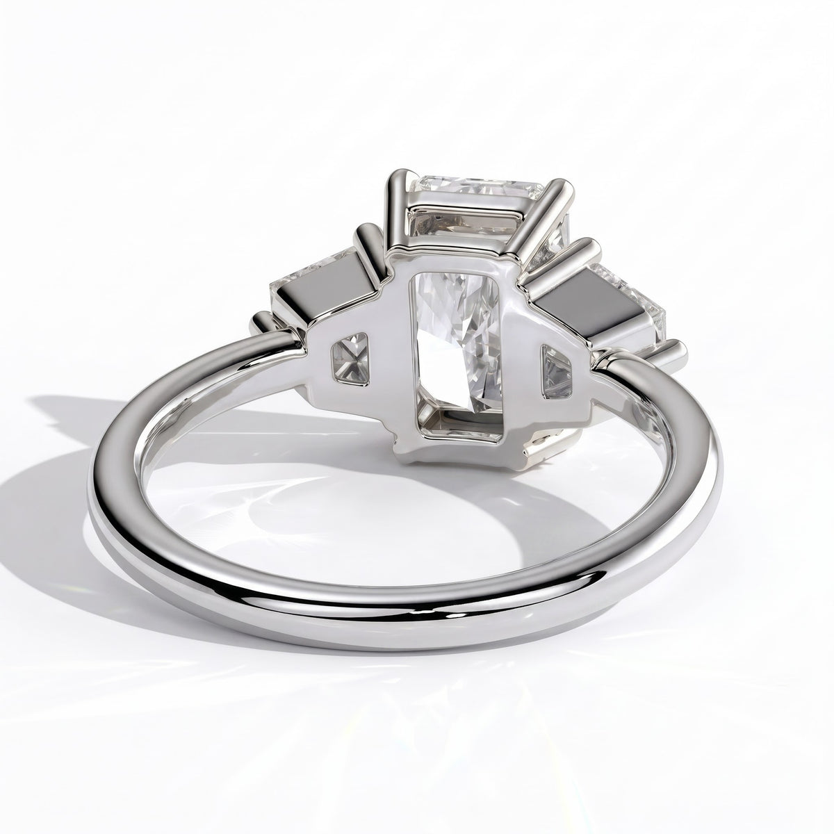Radiant lab-grown diamond three-stone engagement ring in 950 platinum, on white background