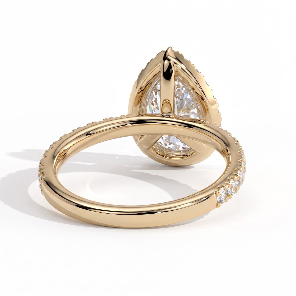 Pear lab-grown diamond halo engagement ring in 14K (585) yellow gold, on white background