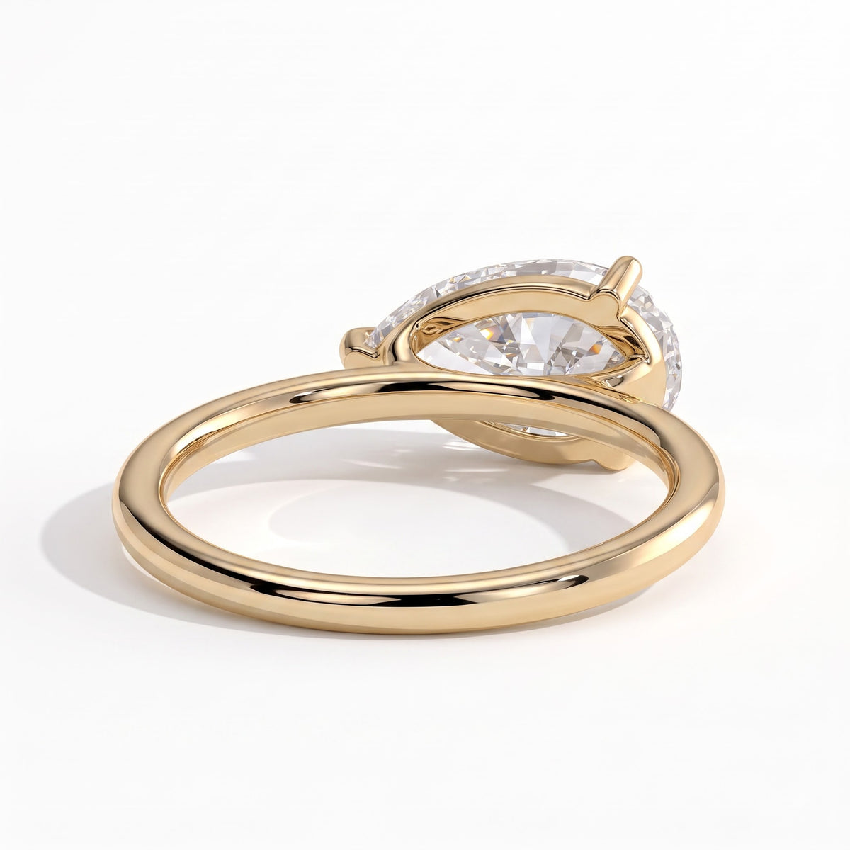 Pear lab-grown diamond east-west solitaire engagement ring in 14K (585) yellow gold, on white background