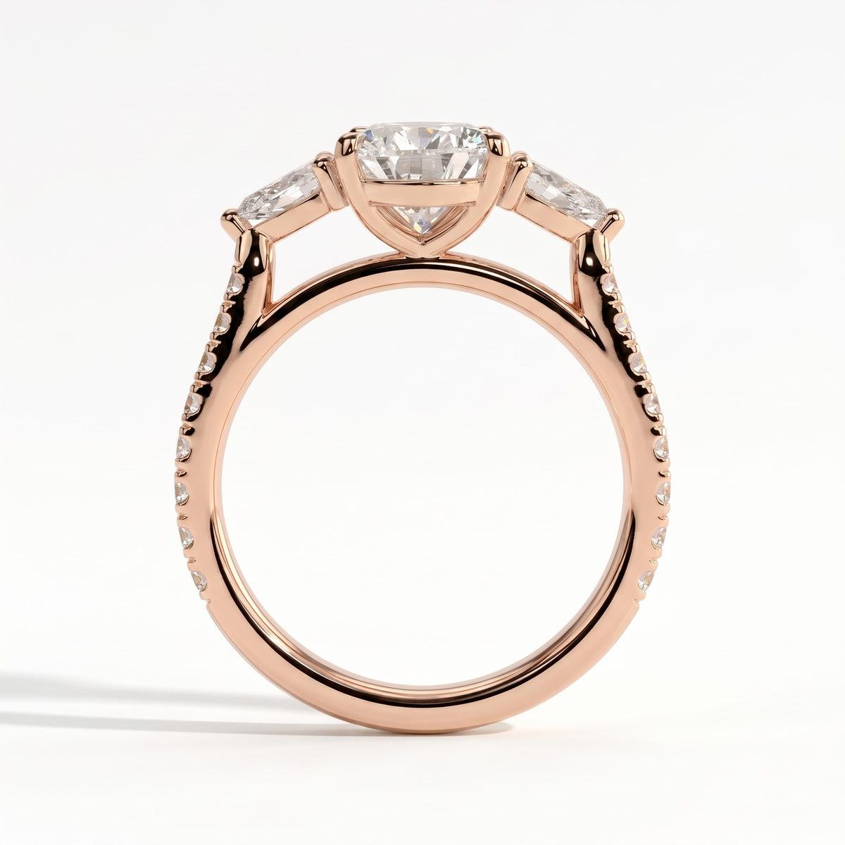 Pear lab-grown diamond three-stone engagement ring in 18K (750) rose gold, side profile
