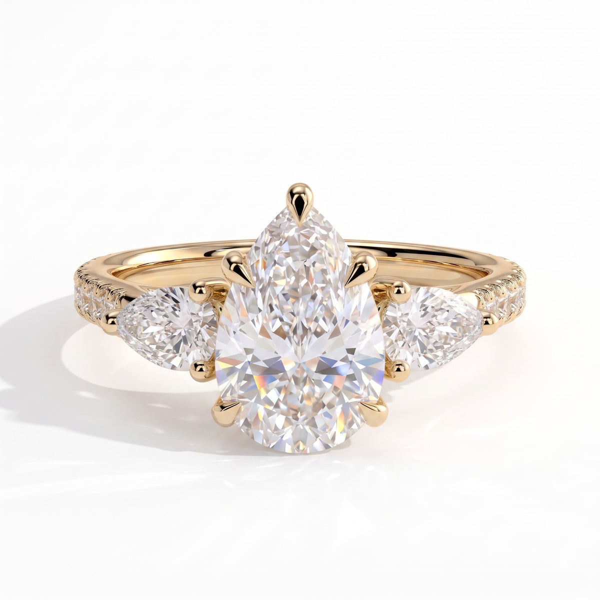 Pear lab-grown diamond three-stone engagement ring in 18K (750) yellow gold, front view