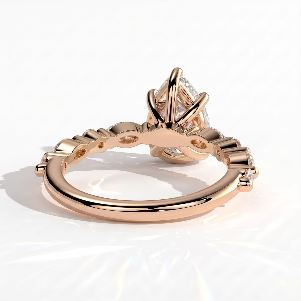 Pear lab-grown diamond halo engagement ring in 14K (585) rose gold, on white background