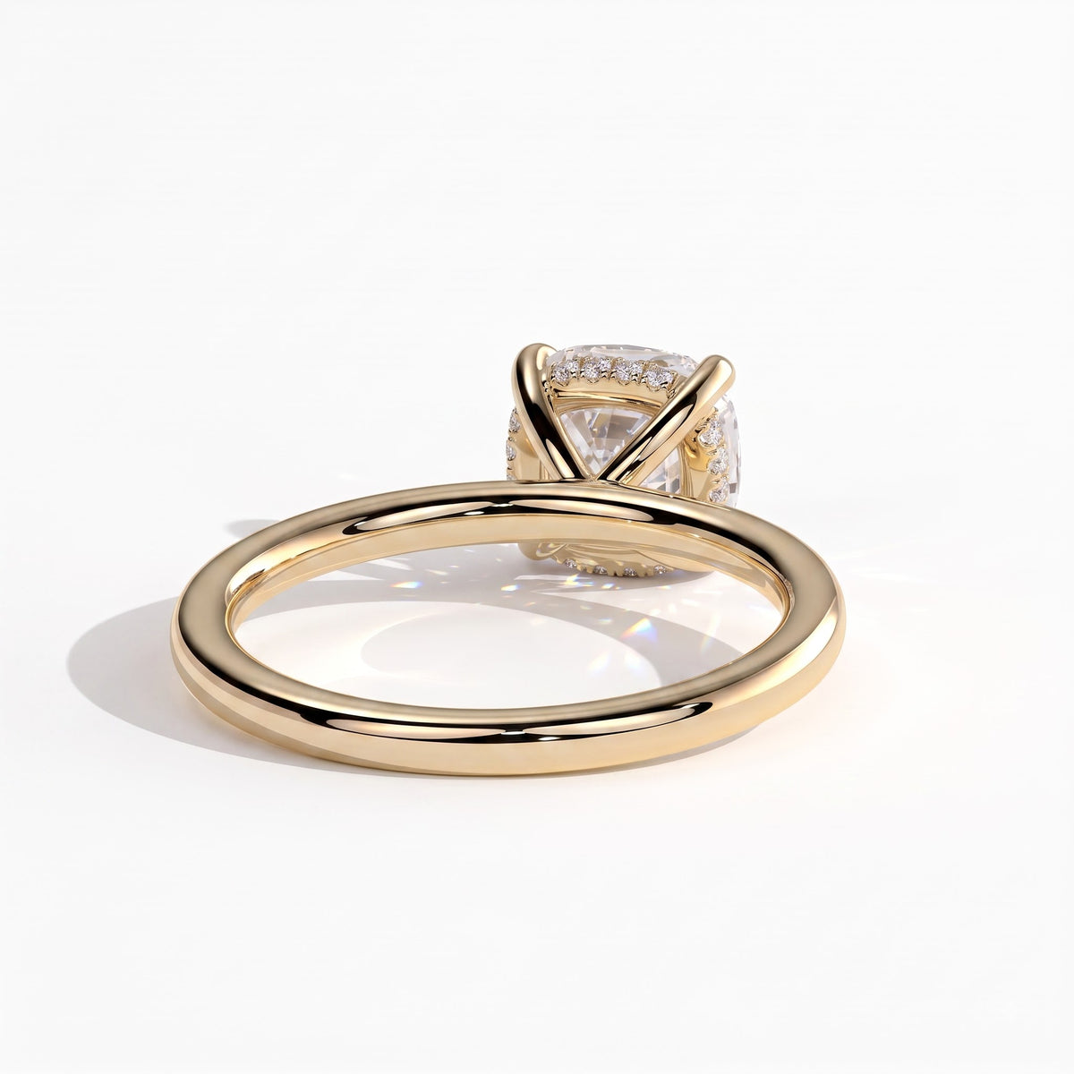Cushion lab-grown diamond solitaire engagement ring in 18K (750) yellow gold, on white background