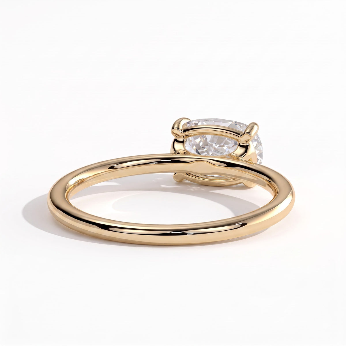 Elongated Cushion lab-grown diamond east-west solitaire engagement ring in 18K (750) yellow gold, on white background
