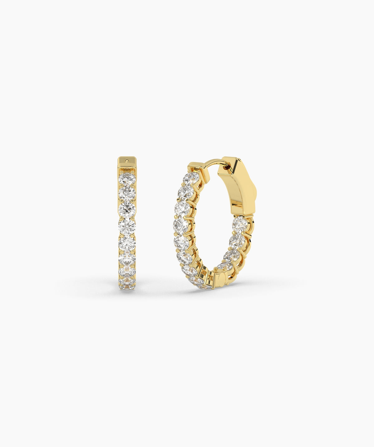 Gold hoop earrings with clear gemstones on a white background.