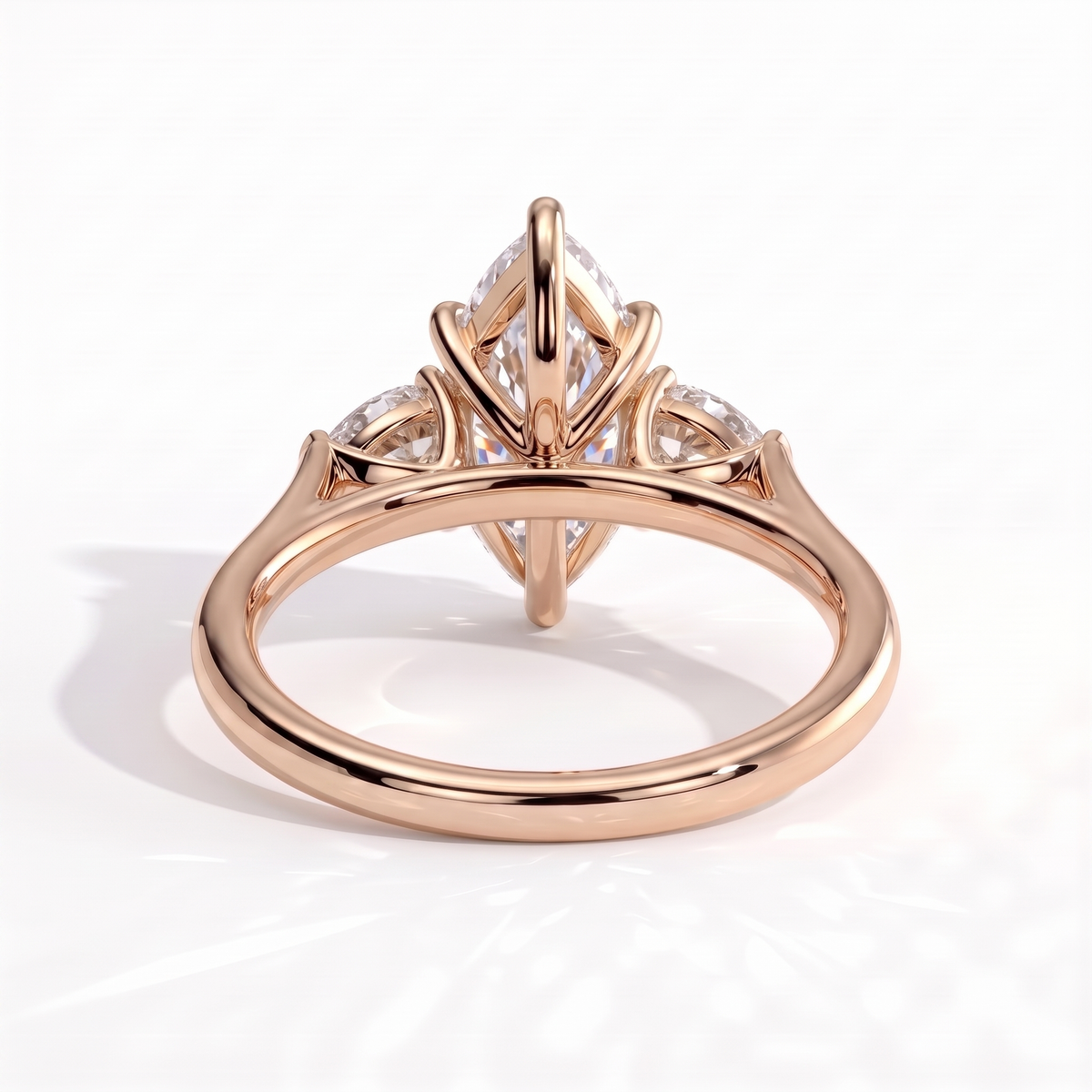 Marquise lab-grown diamond three-stone engagement ring in 18K (750) rose gold, on white background
