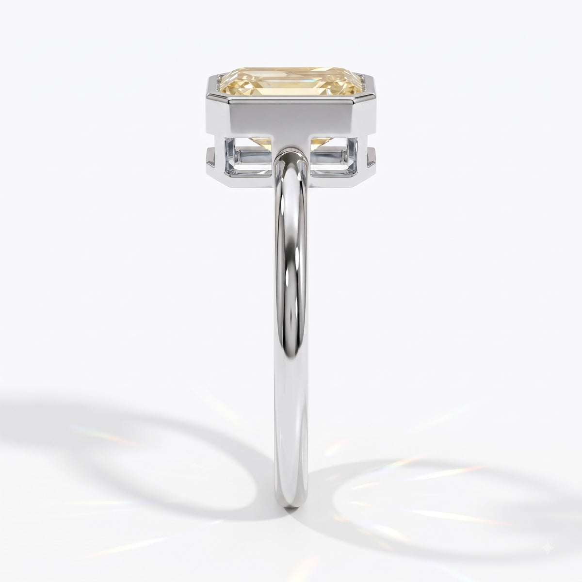 Fancy Intense Yellow emerald cut lab-grown diamond bezel ring in 18K (750) white gold, side profile