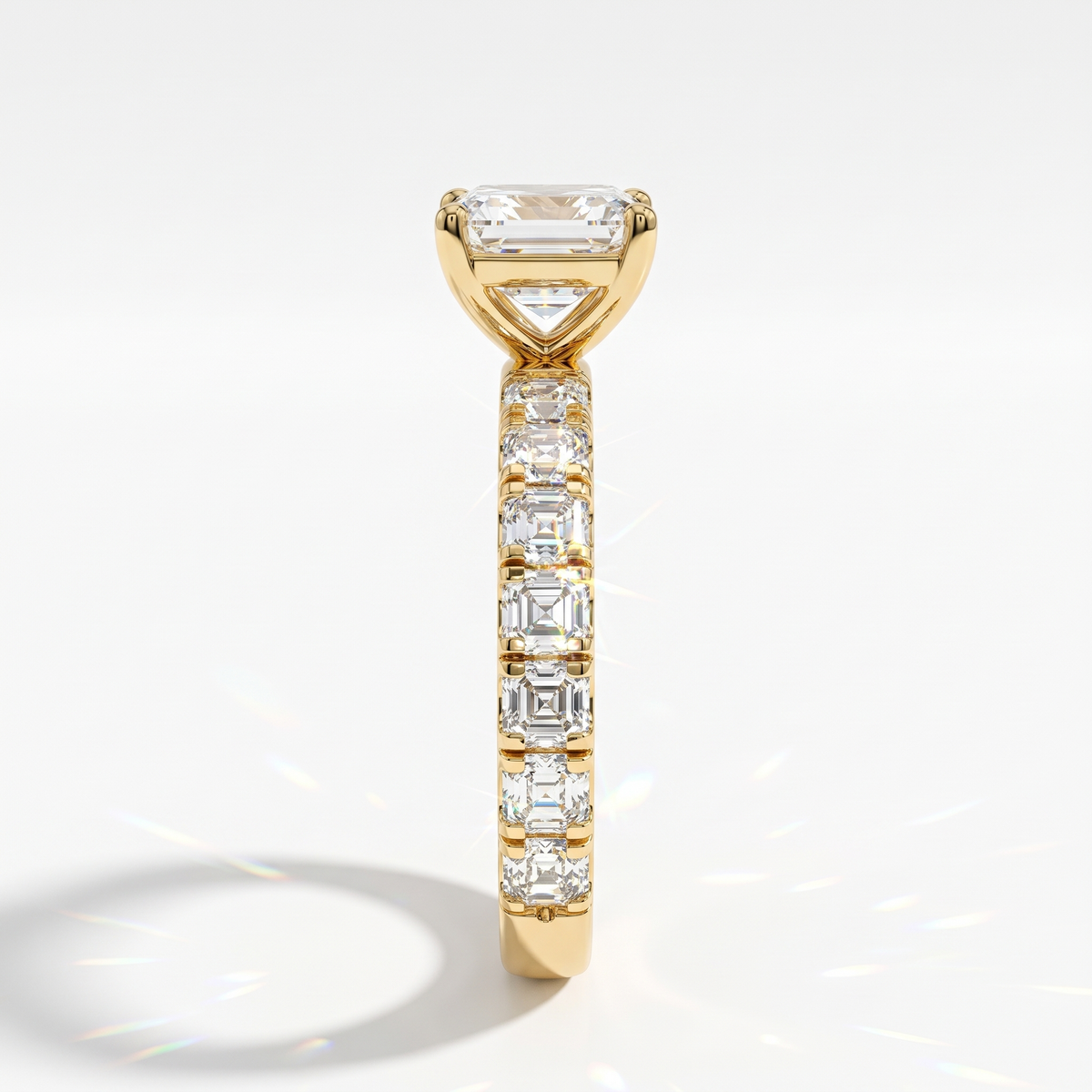Asscher cut lab-grown diamond engagement ring with Asscher side stones in 14K (585) yellow gold, side view