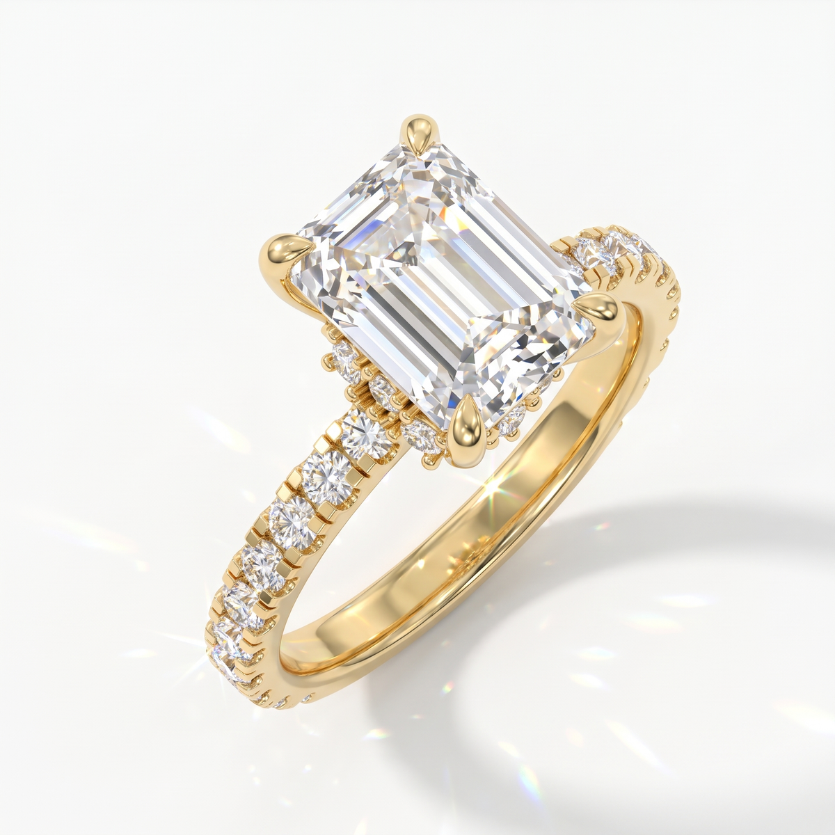 Emerald cut lab-grown diamond hidden halo collar engagement ring with pavé band in 14K (585) yellow gold, angled view