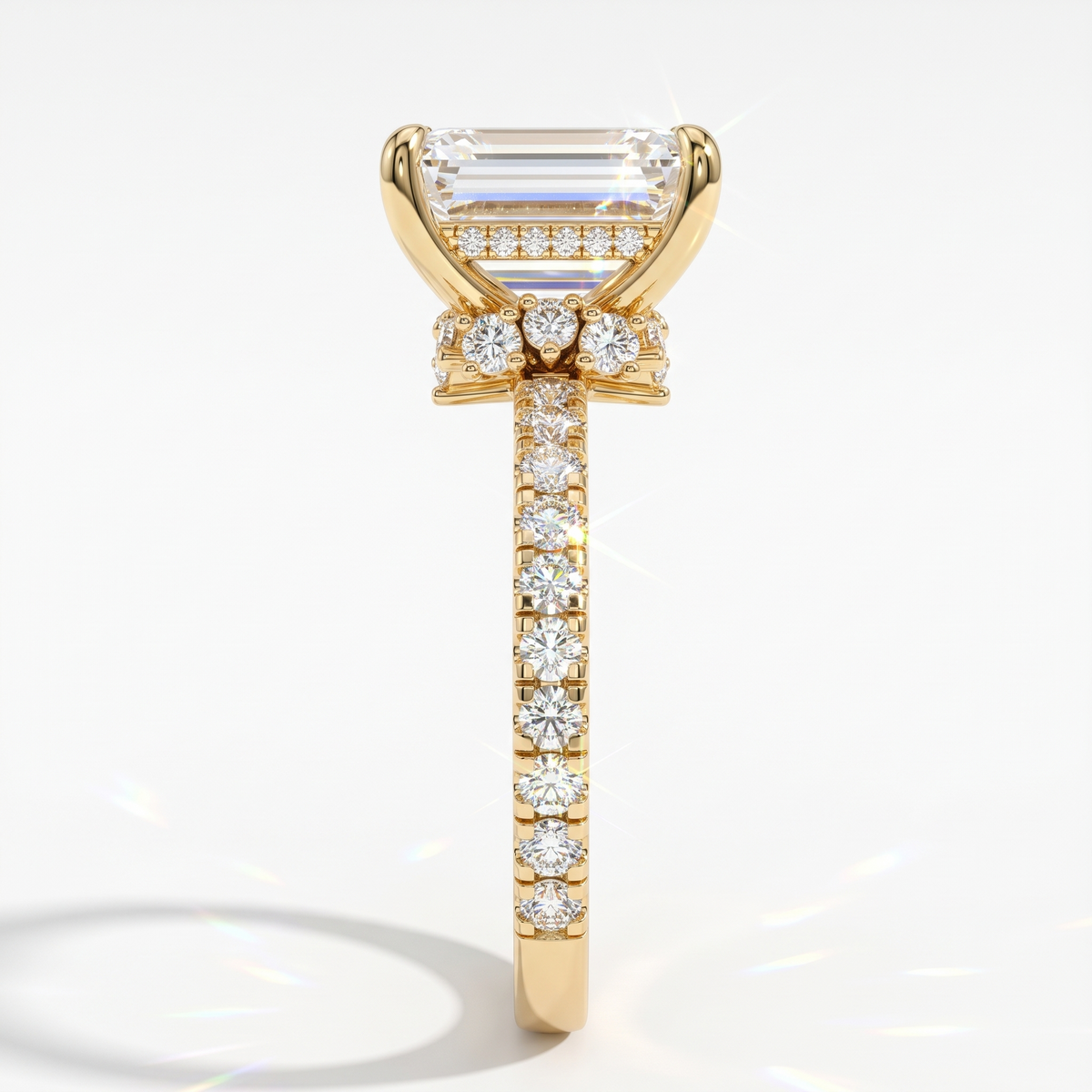 Emerald cut lab-grown diamond hidden halo collar engagement ring with pavé band in 18K (750) yellow gold, side view
