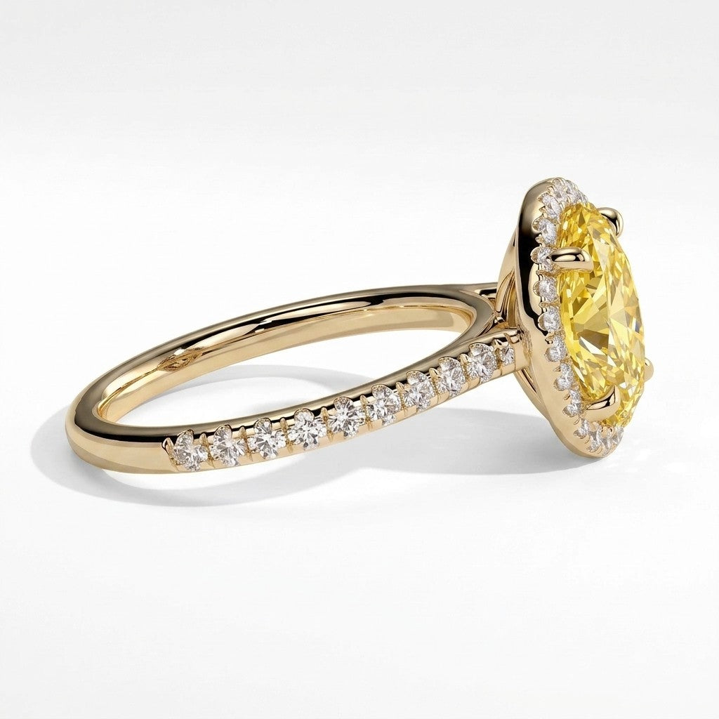 Fancy Vivid Yellow oval lab-grown diamond halo engagement ring with cathedral pavé band in 18K (750) yellow gold, detail view of the halo and pavé band