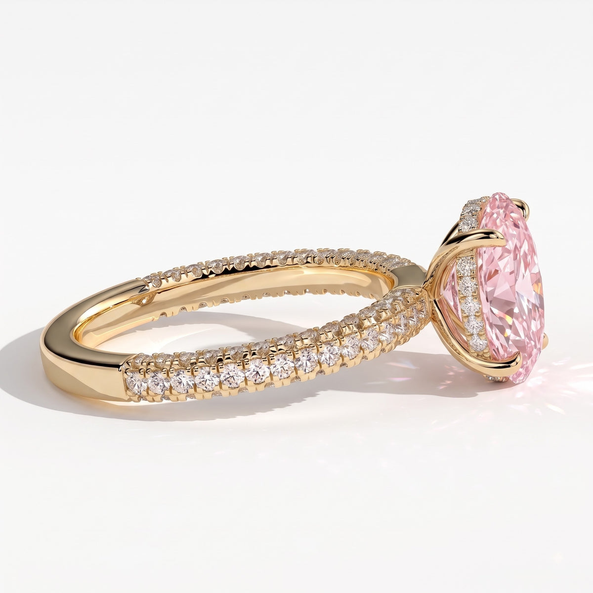 Fancy Vivid Pink oval lab-grown diamond engagement ring with triple pavé band and hidden halo in 14K (585) yellow gold, detail view of the triple pavé band