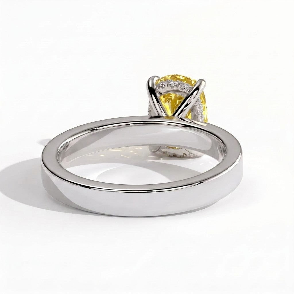 Fancy Vivid Yellow elongated cushion lab-grown diamond engagement ring with flat cigar band and hidden halo in 18K (750) white gold, on white background