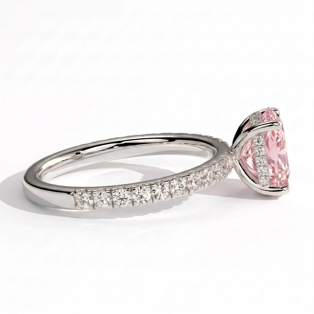 Fancy Vivid Pink elongated cushion lab-grown diamond engagement ring with hidden halo and pavé band in 950 platinum, detail view of the pavé band