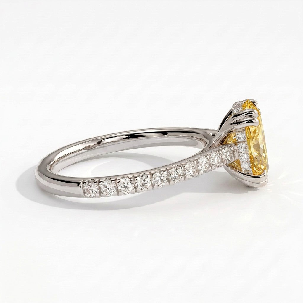 Fancy Vivid Yellow oval lab-grown diamond double claw engagement ring with pavé band and hidden halo in 950 platinum, detail view of the pavé band