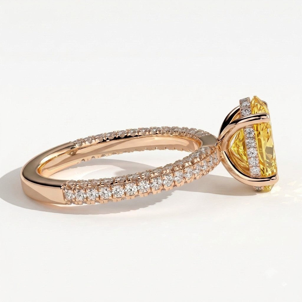 Fancy Vivid Yellow oval lab-grown diamond engagement ring with triple pavé band and hidden halo in 14K (585) rose gold, detail view of the triple pavé band