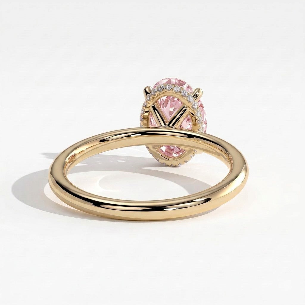 Fancy Vivid Pink oval lab-grown diamond engagement ring with wrap-around hidden halo in 14K (585) yellow gold, on white background