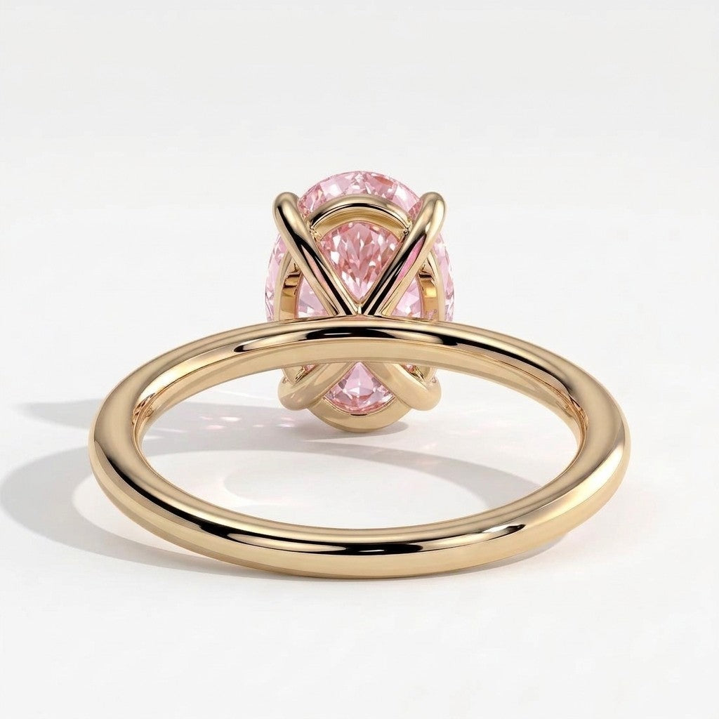 Fancy Vivid Pink oval lab-grown diamond solitaire engagement ring in 18K (750) yellow gold, on white background