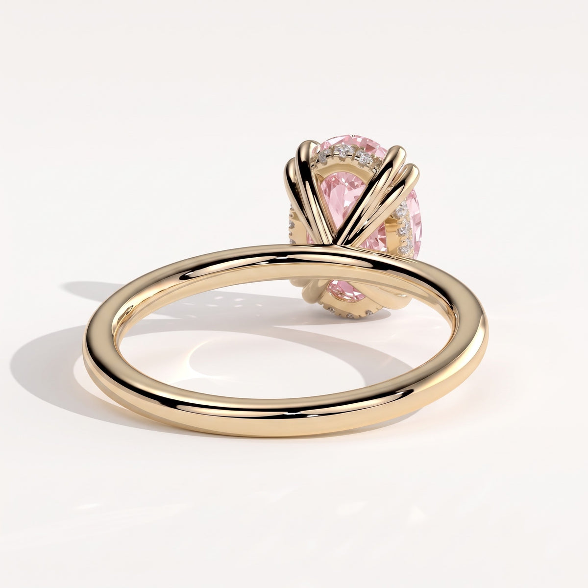 Fancy Vivid Pink oval lab-grown diamond double claw engagement ring with hidden halo in 14K (585) yellow gold, back view