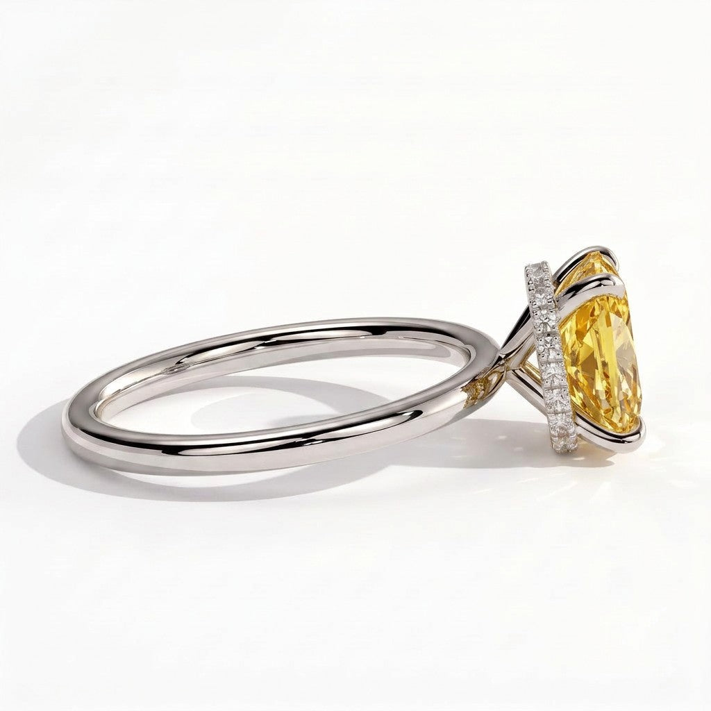Fancy Vivid Yellow elongated cushion lab-grown diamond engagement ring with wrap-around hidden halo in 14K (585) white gold, detail view of the wrap-around hidden halo