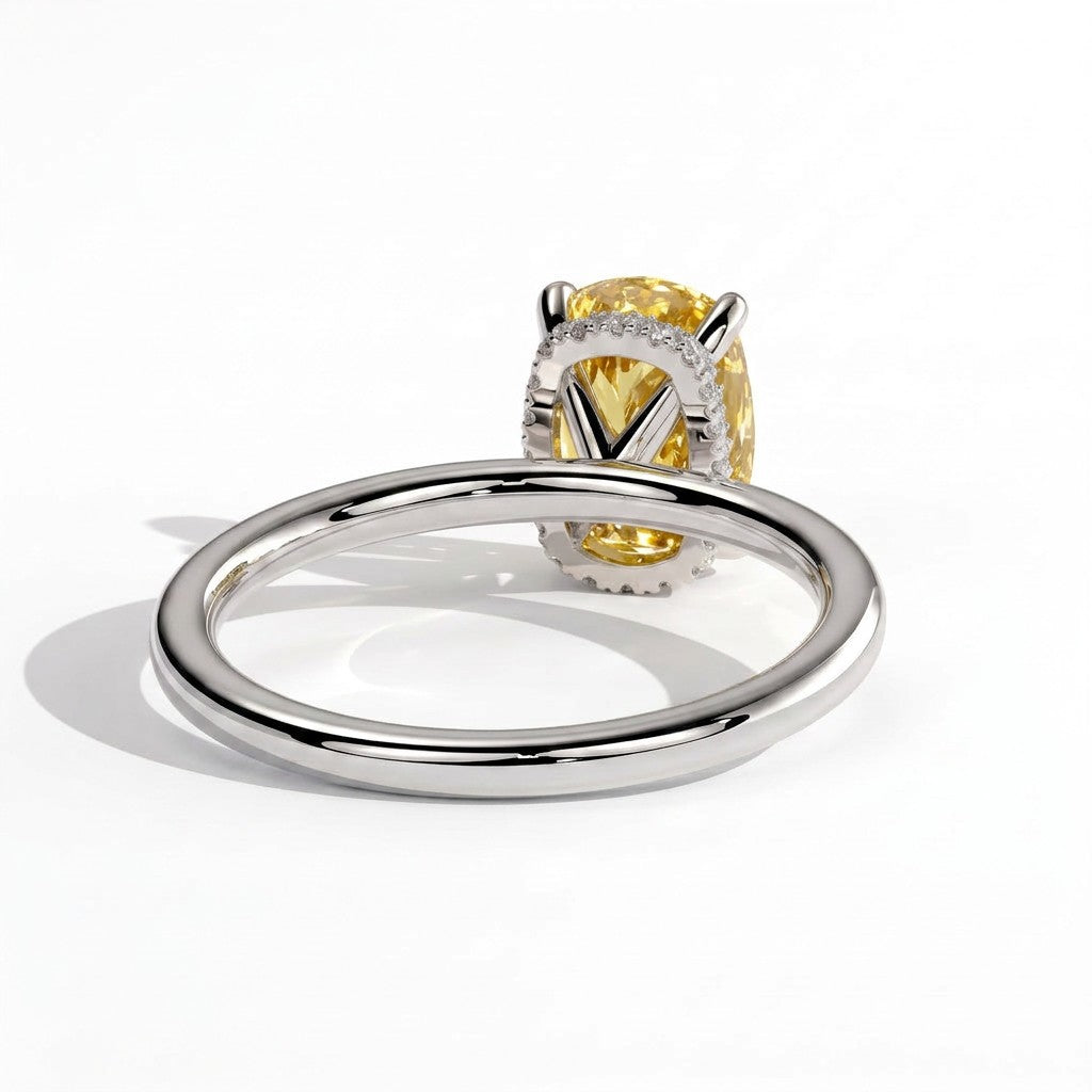 Fancy Vivid Yellow elongated cushion lab-grown diamond engagement ring with wrap-around hidden halo in 18K (750) white gold, on white background
